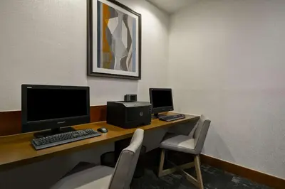 a desk with a computer and a monitor and a chair at Hyatt Place Miami Airport-West/Doral in Miami