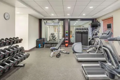 a gym with several treadmills and cardio machines at Hilton Garden Inn Miami Airport West in Miami