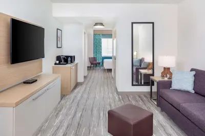 a living room with a couch and a flat screen tv at Hilton Garden Inn Miami Airport West in Miami