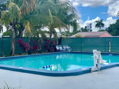 a large swimming pool with two chairs at The Hollywood Gateway Inn in Hollywood