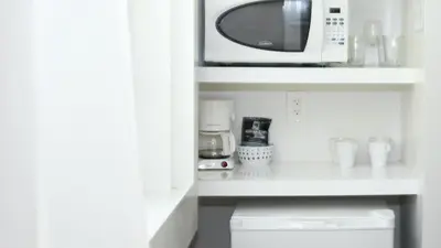 a microwave sitting on a shelf in a kitchen at Riviere South Beach Hotel in Miami Beach
