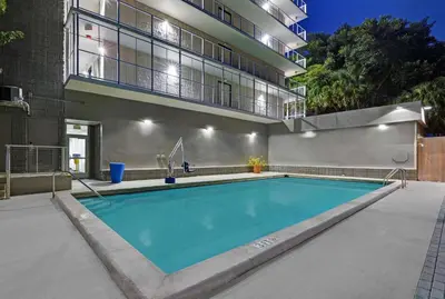 a swimming pool in front of a building at Motel 6-Cutler Bay, FL in Cutler Bay