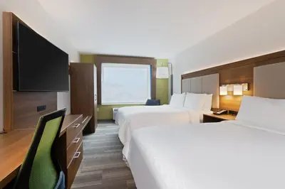 a hotel room with two beds and a flat screen tv at Holiday Inn Express Ft Lauderdale Cruise-Airport by IHG in Fort Lauderdale