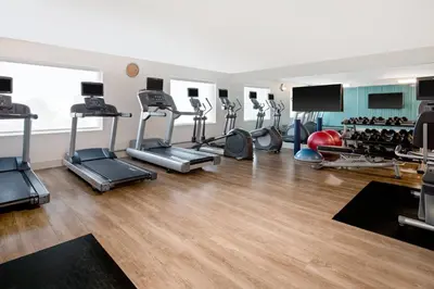 a gym with a lot of treadmills and machines at Holiday Inn Express Ft Lauderdale Cruise-Airport by IHG in Fort Lauderdale