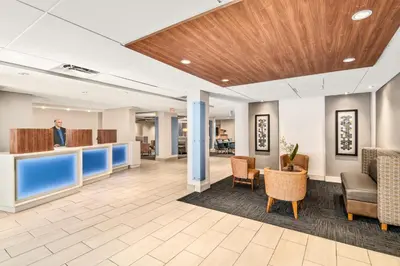 a lobby of a hospital with chairs and tables at Holiday Inn Express Ft Lauderdale Cruise-Airport by IHG in Fort Lauderdale