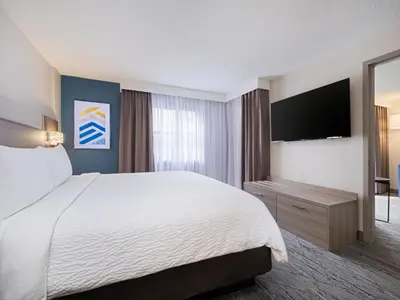 a hotel room with a bed and a flat screen tv at Holiday Inn Express Hotel & Suites Ft. Lauderdale-Plantation by IHG in Plantation