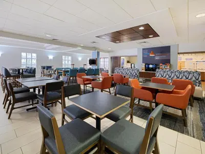a dining room with tables and chairs at Holiday Inn Express Hotel & Suites Ft. Lauderdale-Plantation by IHG in Plantation