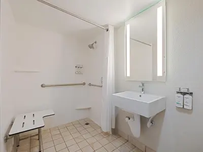a white bathroom with a sink and a mirror at Holiday Inn Express Hotel & Suites Ft. Lauderdale-Plantation by IHG in Plantation