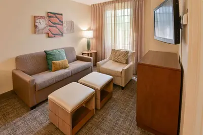 a living room with a couch and a chair at Sonesta ES Suites Fort Lauderdale Plantation in Plantation