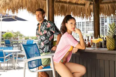 a woman sitting at a bar with a man at DoubleTree Resort Hollywood Beach in Hollywood
