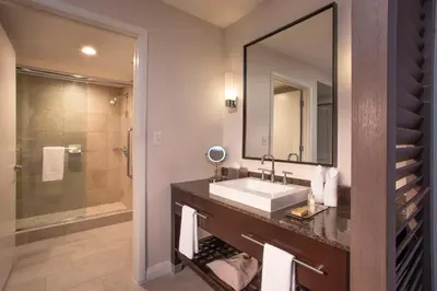 a bathroom with a sink and a mirror and a shower at DoubleTree Resort Hollywood Beach in Hollywood