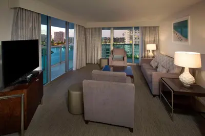a living room with a couch and a flat screen tv at DoubleTree Resort Hollywood Beach in Hollywood