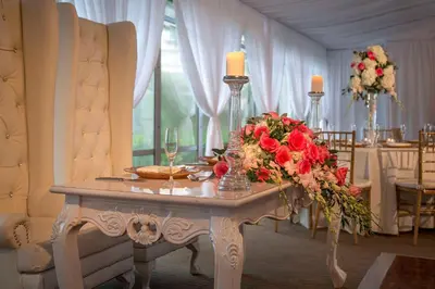 a table with flowers and candles in a room at DoubleTree Resort Hollywood Beach in Hollywood