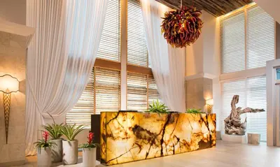 a lobby with a large window and a large tub at Sole Miami, A Noble House Resort in Miami Beach