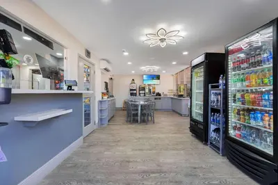 a grocery store aisle with a counter and a drink refrigerator at Quality Inn & Suites Airport-Cruise Port Hollywood in Hollywood