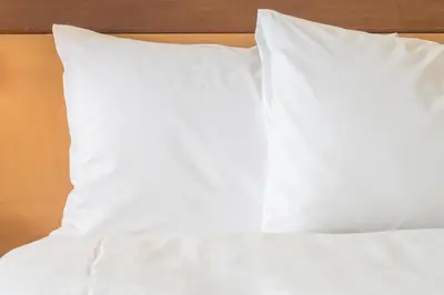 a bed with white sheets and pillows on it at Crowne Plaza Hotel & Resorts Fort Lauderdale Airport/ Cruise by IHG in Fort Lauderdale