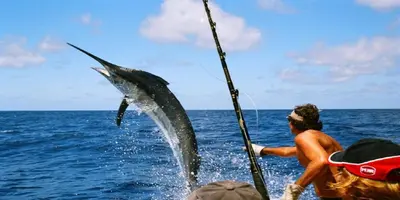 a man is holding a fish in the water at Crowne Plaza Hotel & Resorts Fort Lauderdale Airport/ Cruise by IHG in Fort Lauderdale
