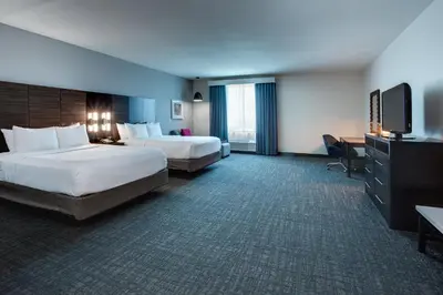 a hotel room with two beds and a flat screen tv at Crowne Plaza Hotel & Resorts Fort Lauderdale Airport/ Cruise by IHG in Fort Lauderdale