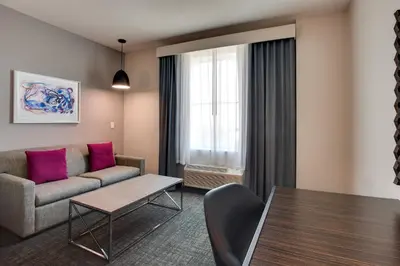 a living room with a couch and a table at Crowne Plaza Hotel & Resorts Fort Lauderdale Airport/ Cruise by IHG in Fort Lauderdale