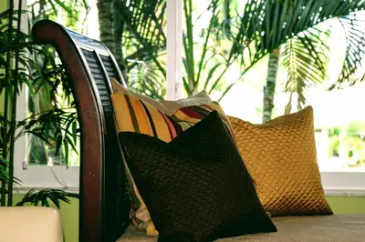 a group of pillows sitting on a bench at Villa Venezia in Fort Lauderdale