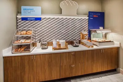 a bakery with a counter with donuts on it at Holiday Inn Express Hotel & Suites Fort Lauderdale Airport/Cruise Port by IHG in Fort Lauderdale