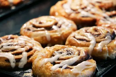 a bunch of donuts with icing on a tray at Holiday Inn Express Hotel & Suites Fort Lauderdale Airport/Cruise Port by IHG in Fort Lauderdale