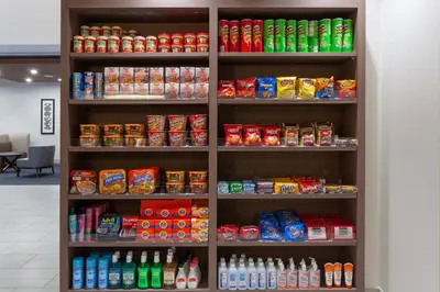 a shelf filled with lots of food and drinks at Holiday Inn Express Hotel & Suites Fort Lauderdale Airport/Cruise Port by IHG in Fort Lauderdale