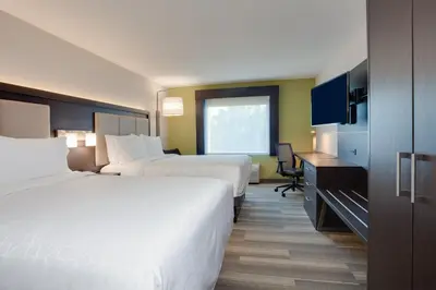 a hotel room with two beds and a desk at Holiday Inn Express Hotel & Suites Fort Lauderdale Airport/Cruise Port by IHG in Fort Lauderdale