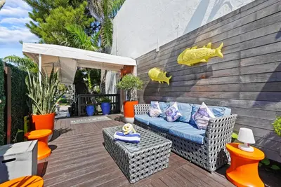 a patio with a couch and a table and chairs at Hollywood Beach Suites and Hotel in Hollywood