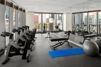 a gym with treadmills and exercise equipment and windows at Dua Miami, Autograph Collection in Miami