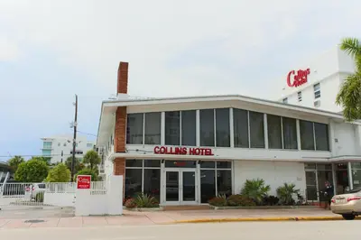 a building with a colums hotel on a street at Collins Hotel in Miami Beach