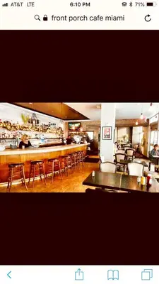 a restaurant with a bar with tables and chairs at Apartment at De Soleil Hotel on Ocean Drive in Miami Beach
