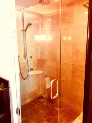 a bathroom with a shower with a glass door at Apartment at De Soleil Hotel on Ocean Drive in Miami Beach