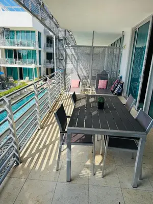 a table and chairs on the balcony of a building at Apartment at De Soleil Hotel on Ocean Drive in Miami Beach