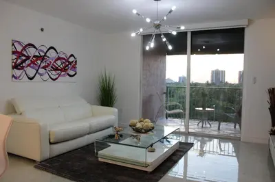 a living room with a white couch and a glass table at Yacht Club at Aventura Luxurious 1 Bed 1 Bath in Aventura