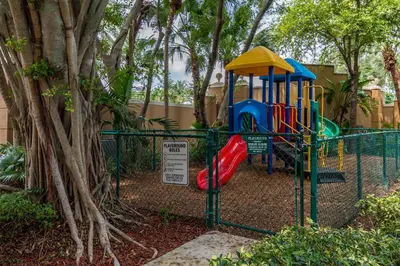 a playground in a park next to a tree at Yacht Club at Aventura Luxurious 1 Bed 1 Bath in Aventura