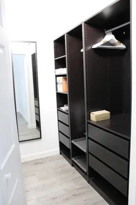 a closet with black drawers and a mirror at Yacht Club at Aventura Luxurious 1 Bed 1 Bath in Aventura