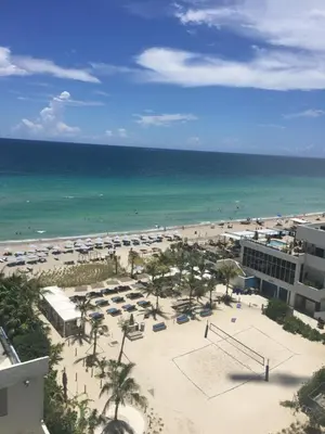 a view of a beach with umbrellas and the ocean at Hollywood apartment by the sea in Hollywood