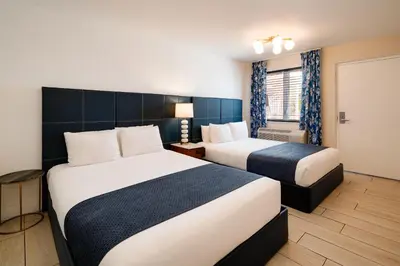a hotel room with two beds and a window at Waterside Hotel and Suites in Miami Beach