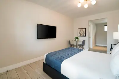 a bedroom with a bed and a flat screen tv at Waterside Hotel and Suites in Miami Beach
