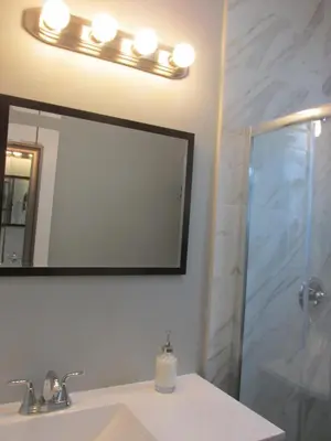 a bathroom with a sink and a mirror and a shower at Ocean Breeze in Miami Beach