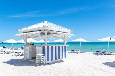 a lifeguard station on a beach with chairs and umbrellas at Global Luxury Suites at Monte Carlo in Miami Beach
