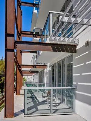 a balcony with a glass table and chairs at ABAE Hotel by Eskape Collection in Miami Beach