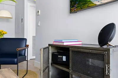 a living room with a table and a chair at ABAE Hotel by Eskape Collection in Miami Beach