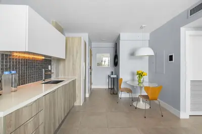 a kitchen and dining room with a table and chairs at ABAE Hotel by Eskape Collection in Miami Beach