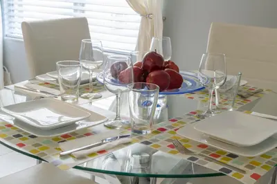 a table with glasses and a plate of fruit on it at Suite Love in Miami Beach