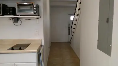 a small kitchen with a counter and a microwave at Fatimataj Mahal in Miami