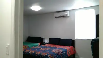a bedroom with a bed with a colorful blanket at Fatimataj Mahal in Miami