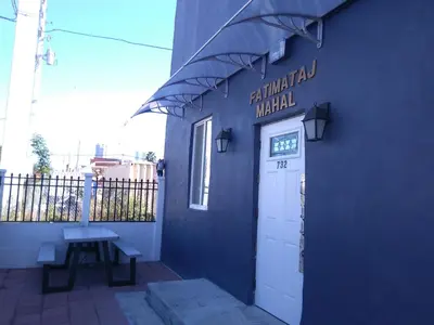 a blue building with a door and a sign on it at Fatimataj Mahal in Miami