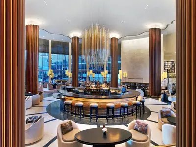 a hotel lobby with a bar with chairs and tables at Nobu Hotel Miami Beach in Miami Beach